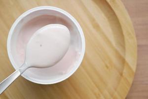 fresh yogurt in a bowl on table photo