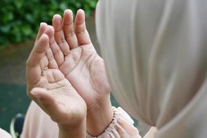 Close up of muslim women hand praying at ramadan photo