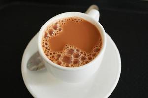 close up of cup of milk tea on table photo