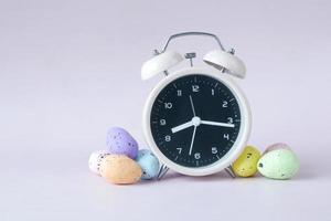 easter concept with egg and a clock on table photo