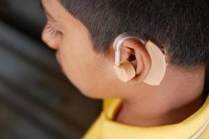 Hearing aid concept, teenage boy with hearing problems. photo