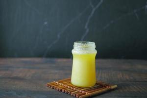 homemade ghee in container on a dark background photo
