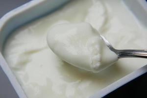 fresh yogurt in a bowl on table photo