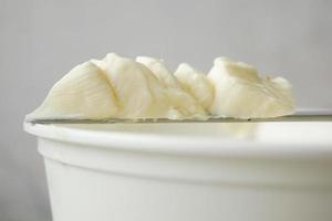 close up of fresh butter in a container photo