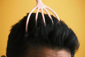 men having a scalp massage with a brush , photo