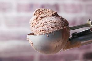 hand picking ice cream with a spoon from a bowl photo