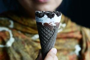 young women eating chocolate flavor ice cream photo