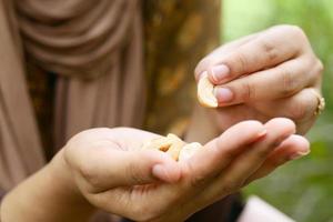 women eating cashew nut close up photo