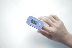 close up of man hand using pulse oximeter photo