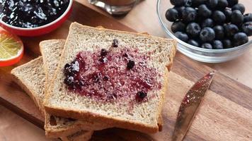 Putting blueberry spread on sliced bread video