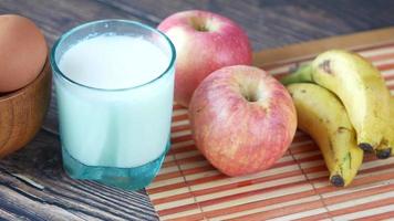 A bowl with eggs, a glass of milk, apples and bananas video
