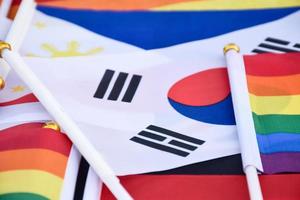 Rainbow flags and flags of many countries on floor, concept for celebration of lgbtq plus genders in pride month around the world, soft and selective focus. photo