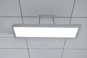 Ceiling lamp installed on the ceiling of the classroom, soft focus. photo