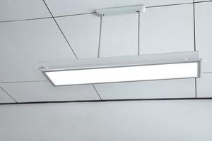Ceiling lamp installed on the ceiling of the classroom, soft focus. photo