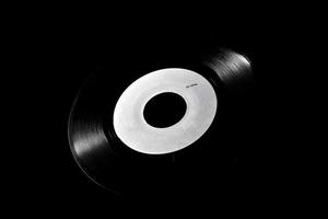 45 rpm vinyl disk on dark background photo