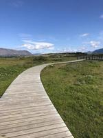 Wooden footpath leading through Thingvellir in Iceland photo