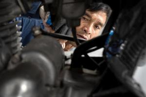 People are repairing a motorcycle Use a wrench and a screwdriver to work photo