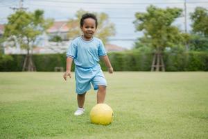 Cute little boy with soccer ball in the park on a sunny day. photo