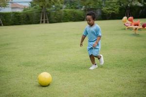 Cute little boy with soccer ball in the park on a sunny day. photo