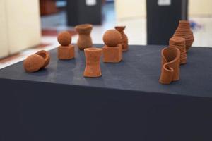 clay art in the form of a flower vase on display on the table photo