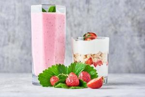 yogur de fresa y granola de cerca sobre un fondo gris foto