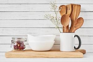 Kitchen tools and cutting board on white table photo