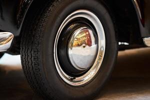 Vintage wheel with protector of retro car, closeup photo