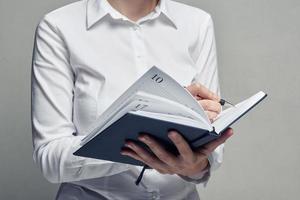 Businesswoman with organizer diary in her hands photo