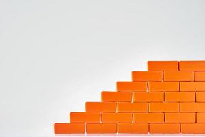 Wall made of a toy bricks. Block stacking as step stair photo