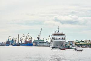 working crane bridge in shipyard and cargo ships in a port photo