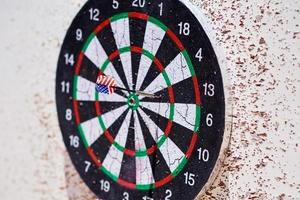 Dartboard with darts. Hit group of target in a dart game photo