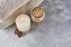 toallas, velas y aceite de masaje en mesa blanca foto