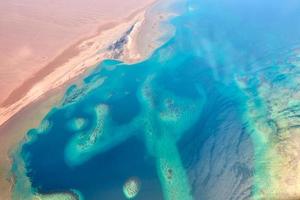 Aerial view of turquoise sea coast and a sandy beach photo