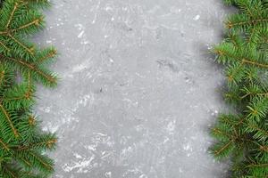 Christmas gray cement background with fir tree and copy space. top view empty space for your design photo