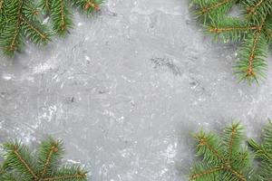 Christmas gray cement background with fir tree and copy space. top view empty space for your design photo