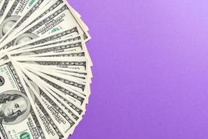 US Dollars Untidy fan of various US dollar bills Top view of business concept on colored background photo