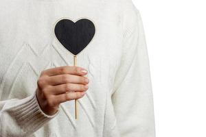 Girl holding Black heart board on white background , Valentines Day photo