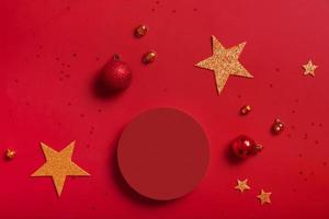 Mock up podium or pedestal for skincare beauty products and Christmas decorations top view on red background photo