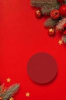 Mock up podium or pedestal for skincare beauty products and Christmas decorations top view on red background photo