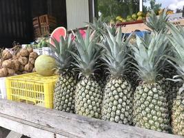 Fresh pineapple neatly arranged in traditional market photo