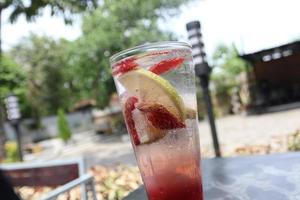 Strawberry mojito drink and a little fresh lemon photo