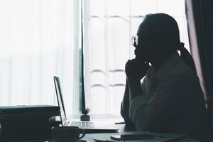 Stress business woman person from hard work, depression in office. Tired and anxious employee female with unhappy at problem job. young businesswoman sitting sad front of laptop computer on desk. photo