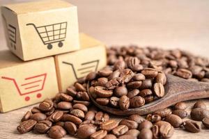 Box with shopping cart logo symbol on coffee beans, Import Export Shopping online or eCommerce delivery service store product shipping, trade, supplier concept. photo