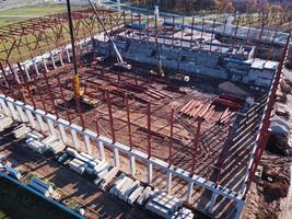 Unfinished metal frame of the building on a concrete base. photo