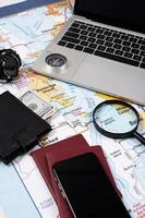 traveler accessories with map, devices and clothes on white background photo