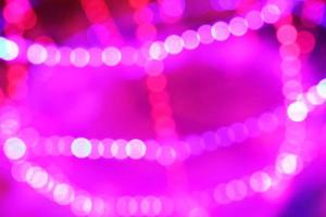 Defocused abstract pink glitter lights background. photo