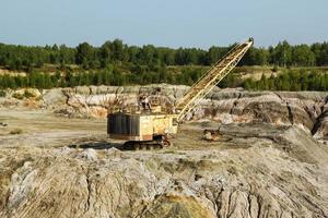 Old quarry for the extraction of clay with excavator. photo