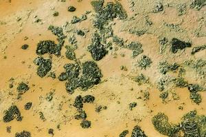 View on a surface of dried lake with polluted water and soil. photo
