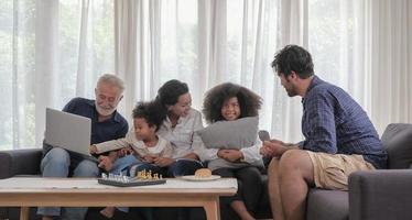 Diversity caucasian - african family group happy spending time together in cozy living room warmth house on holiday. Selective focus. photo