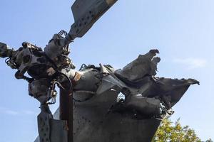 Burnt parts of the destroyed Russian Air Force combat helicopter Hind Crocodile. The wreckage of a downed helicopter. War in Ukraine. Broken military attack helicopter close-up. photo